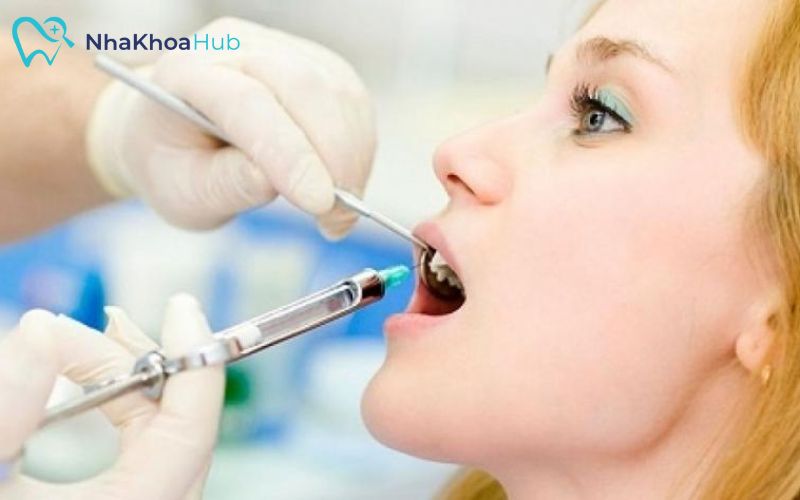 Nha sĩ tiêm thuốc gây tê cục bộ, giúp bệnh nhân không thấy đau